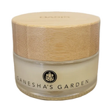Glass jar with wooden lid labeled 'Ganesha's Garden' on a white background